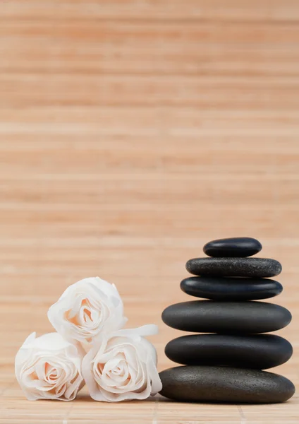 Rosor och en svart pebbles stack — Stockfoto