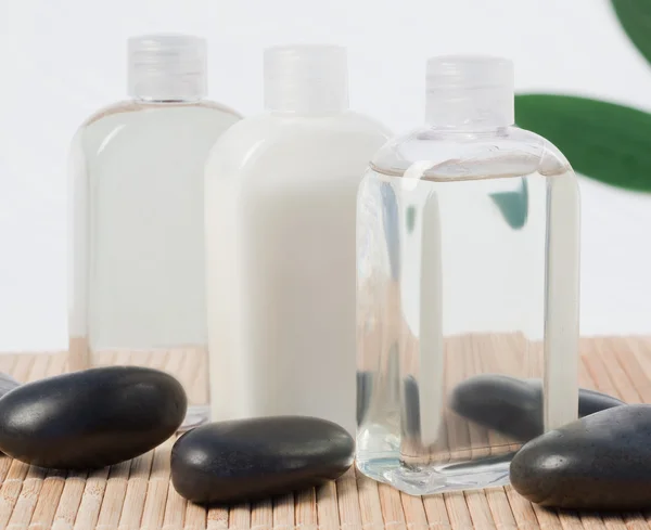 Černé kameny a masážní olej — Stock fotografie