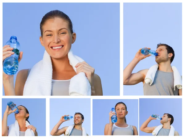 Ungt par vila och dricka lite vatten efter jogging — Stockfoto