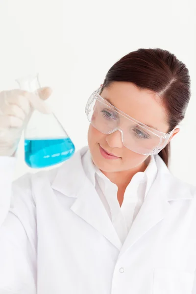 Attractive scientist holding a beaker in a laboratory Stock Photo