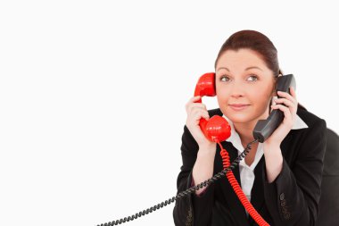 Cute secretary answering two phone calls at the same time clipart