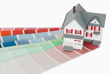 A maniature house and a color chart clipart