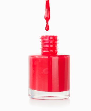 Portrait of a red nail polish droping in its flask clipart