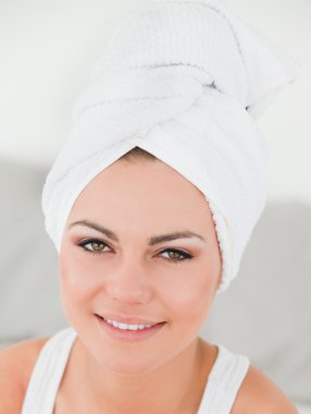 Close up of a woman with the hair wrapped into a towel clipart