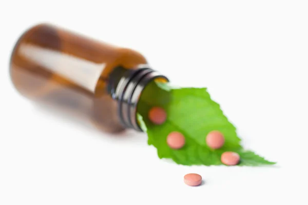 Leaf and pills in a small bottle — Stock Photo, Image