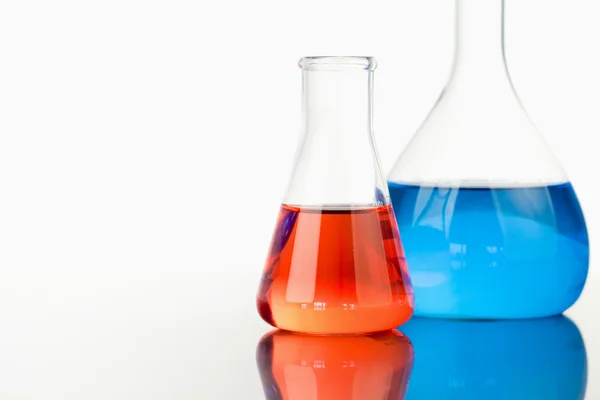Blue and red beakers — Stock Photo, Image