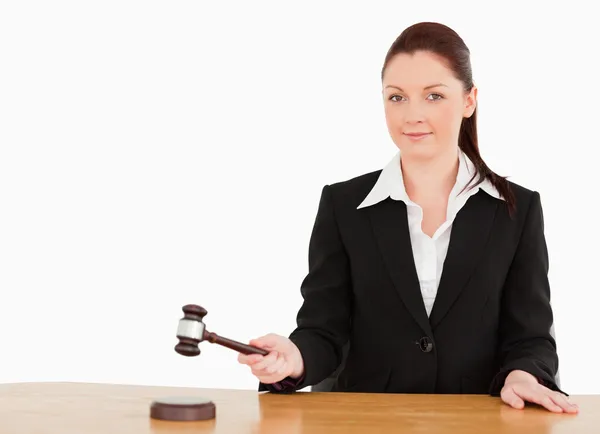 Young judge knocking a gavel smiling at the camera — Stock Photo, Image