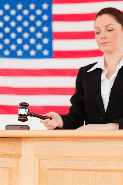 Portrait of a focused judge knocking a gavel — Stock Photo, Image