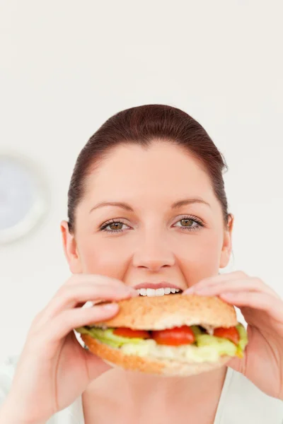 Gorgeous woman eating a sandwich for lunch — Stock Photo, Image