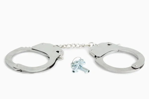Metallic handcuffs and keys — Stock Photo, Image