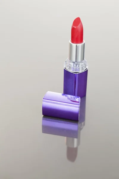 Portret van een rode lippenstift met een paarse buis — Stockfoto