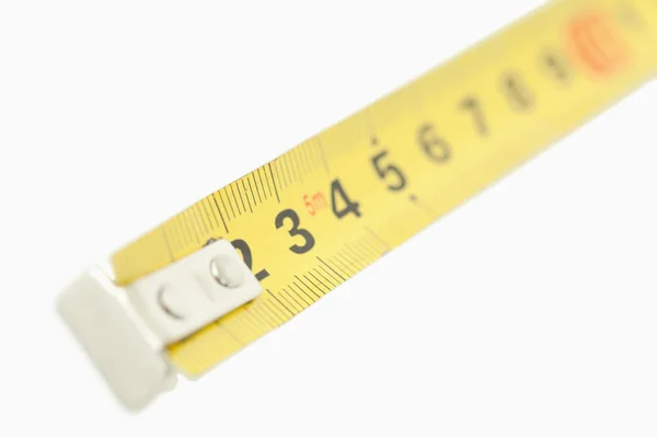 Camera focus on a yellow measuring tape — Stock Photo, Image