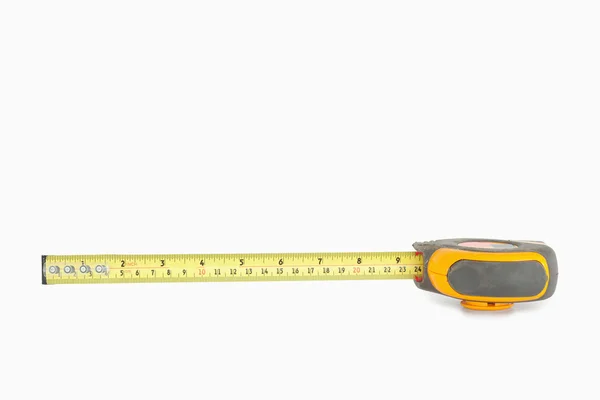 Yellow measuring tape partly unrolled — Stock Photo, Image