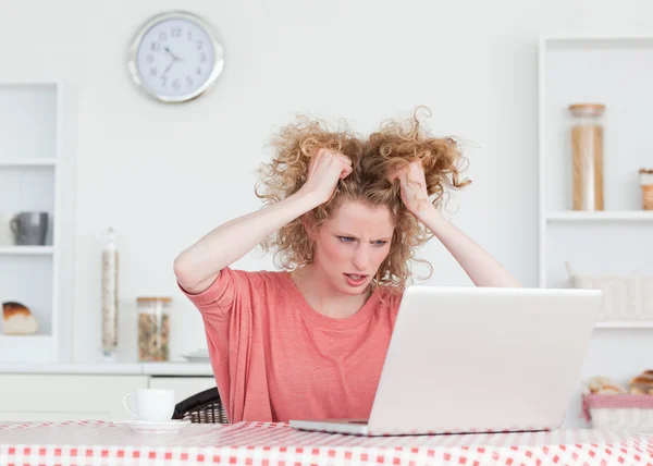 Αναστατωμένος ξανθιά γυναίκα χαλάρωση με το laptop της καθμένος φώ — Φωτογραφία Αρχείου