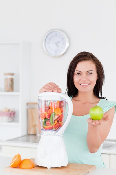 Woman with a blender and an apple — Stock Photo, Image