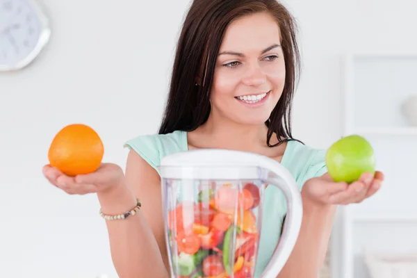 Charming woman with a blender and fruits — Stock Photo, Image