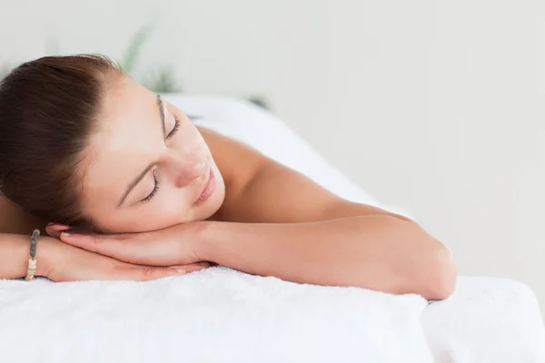 Close up of a cute brunette lying on a massage table — Stock Photo, Image