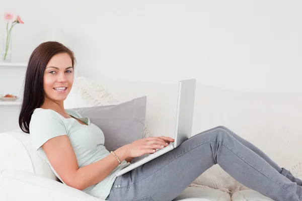 Cute brunette typing on her laptop — Stock Photo, Image