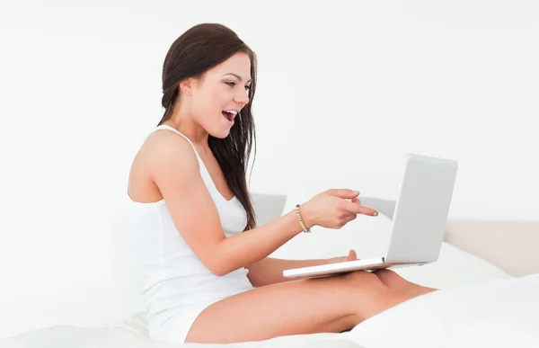 Laughing brunette with her laptop — Stock Photo, Image
