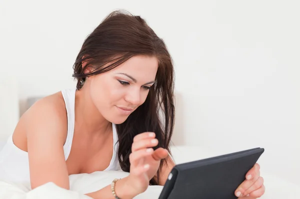 Young brunette with a tablet — Stock Photo, Image