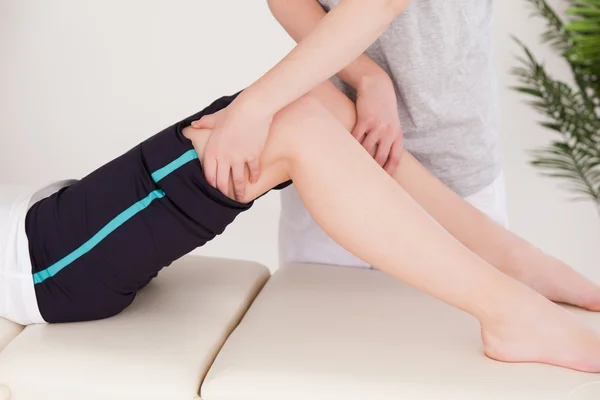 Sportswoman having a leg massage — Stock Photo, Image