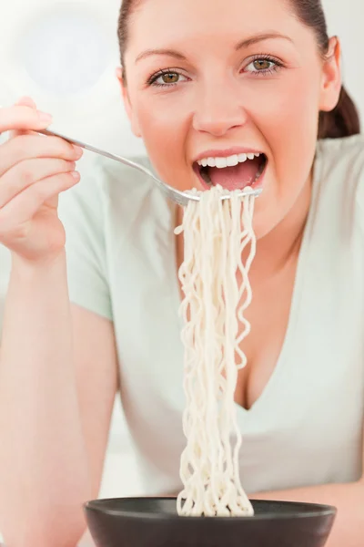 Attractive woman posing while eating pasta Royalty Free Stock Images