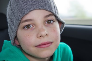 Closeup of cute young teen boy in gray hat clipart