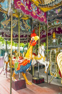 Colorful horses and cock in vintage carousel clipart