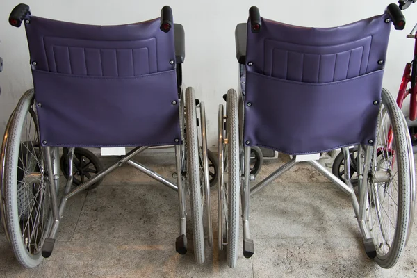 stock image Wheelchair vehicles near the wall