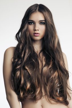 Beautiful woman with perfect skin and long curly hair