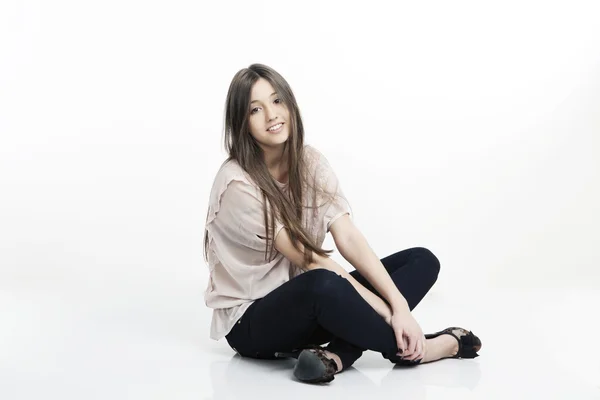 stock image Portrait of beautiful smiling girl with long hair sitting