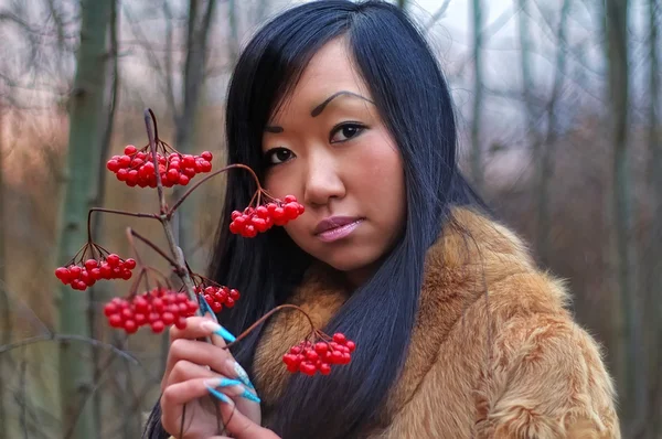 Beautiful woman look on berry — Stock Photo, Image