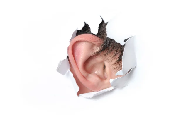 Ear in a hole of paper — Stock Photo, Image