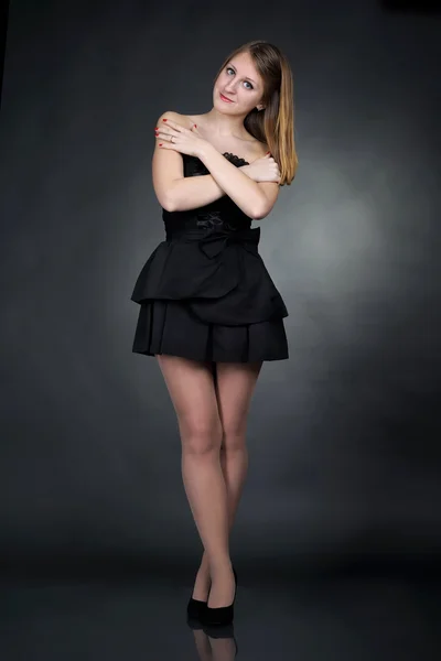 Menina em vestido preto no fundo escuro — Fotografia de Stock