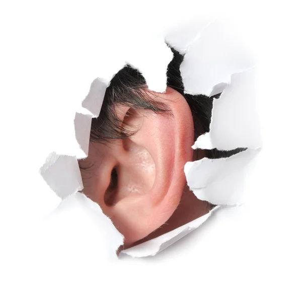 Ear in a hole of paper — Stock Photo, Image