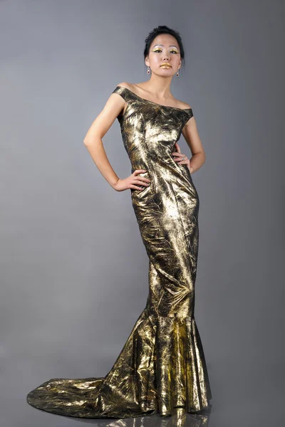 Vacker asiatisk kvinna i gyllene kvällen klänning — Stockfoto