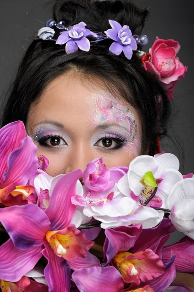 Close-up portrait of asian girl with flowers — Stock Photo, Image