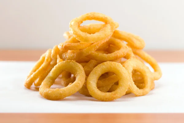 Onion ring on a waxed white paper — Stock Photo, Image