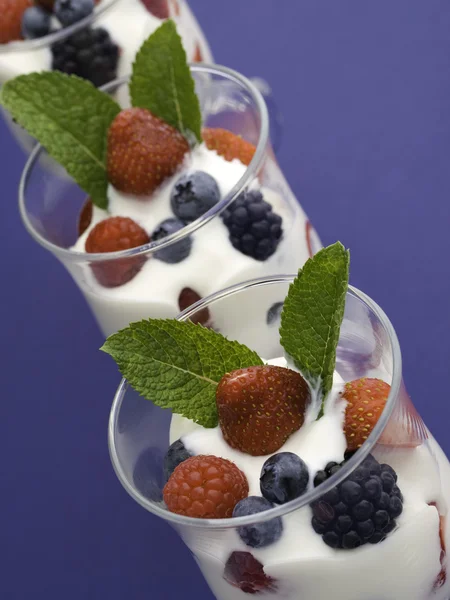 Three yogurt on blue — Stock Photo, Image