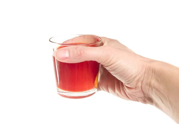 stock image Glass of tomato juice in a hand on a white background