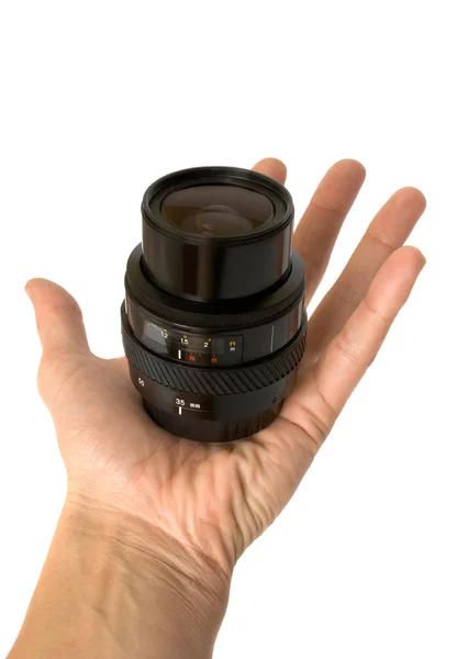 Photographic objective in a hand — Stock Photo, Image