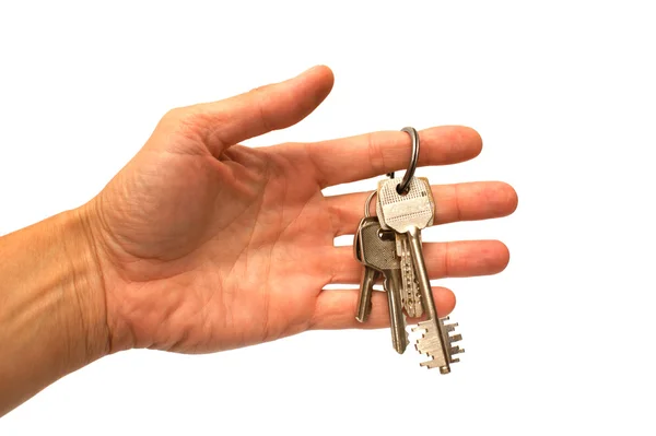 Hand und Schlüssel auf weißem Hintergrund — Stockfoto
