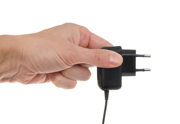 O adaptador elétrico em uma mão, isolado no branco — Fotografia de Stock