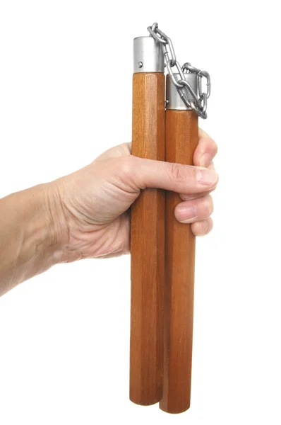 Nunchaku i en hand att isolera på vita — Stockfoto