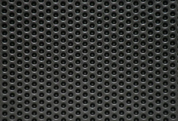 Photo of a natural perforated metal surface Stock Image