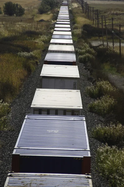 stock image Freight train in the desert mountains.