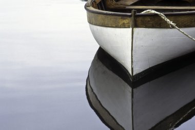 Rowboat and reflection in water clipart