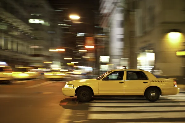 Taxi in de nacht, wazig met beweging — Stockfoto