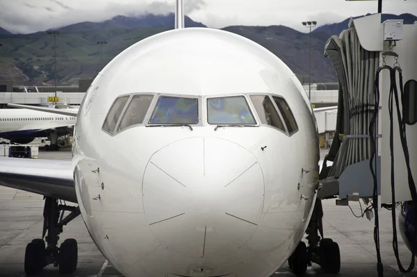 stock image Jet airliner parked at loading gate