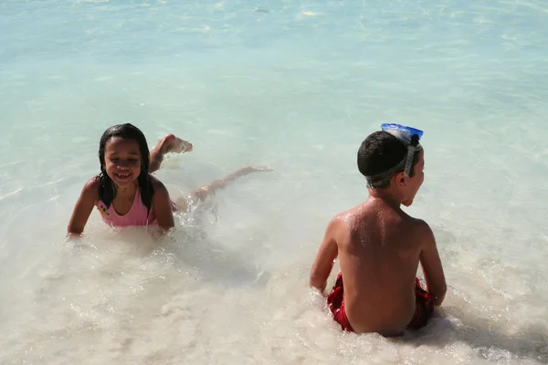 Menina e menino brincando na praia — Fotografia de Stock